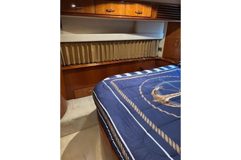 Slide: The Image of Interior cabin of 2004 Carver 396 Motor Yacht with nautical-themed bedding. - 13