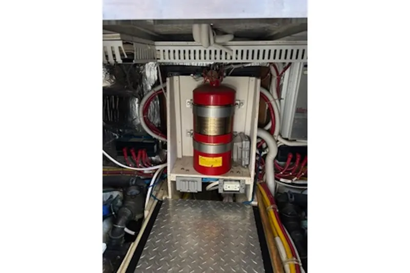 Slide: The Image of Engine room of 2004 Carver 396 Motor Yacht with fire extinguisher and wiring. - 16