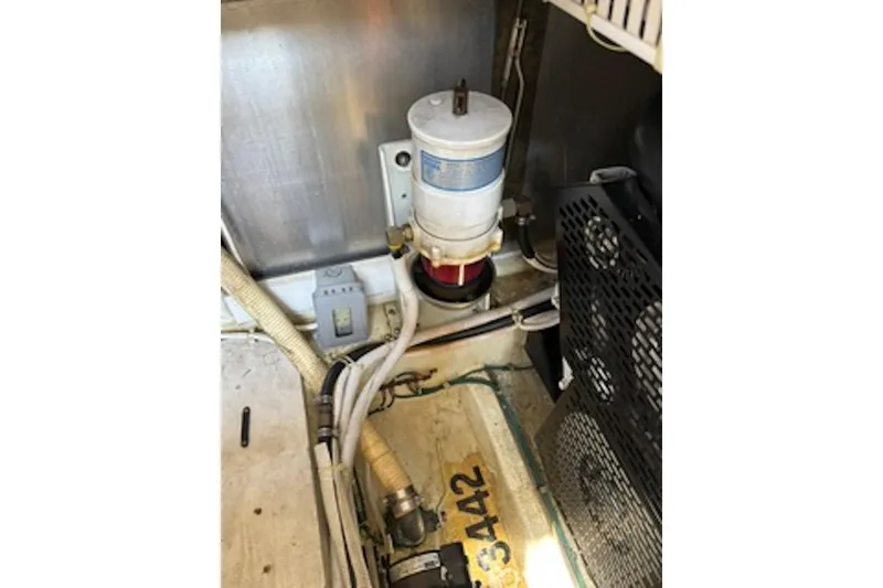 Slide: The Image of Engine room of 2004 Carver 396 Motor Yacht showing fuel filter and wiring. - 17