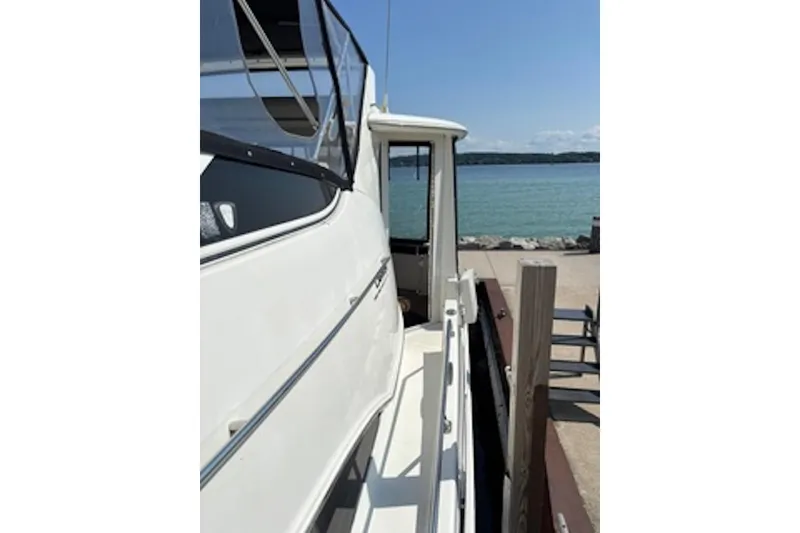 Slide: The Image of 2004 Carver 396 Motor Yacht docked by a serene waterfront. - 2