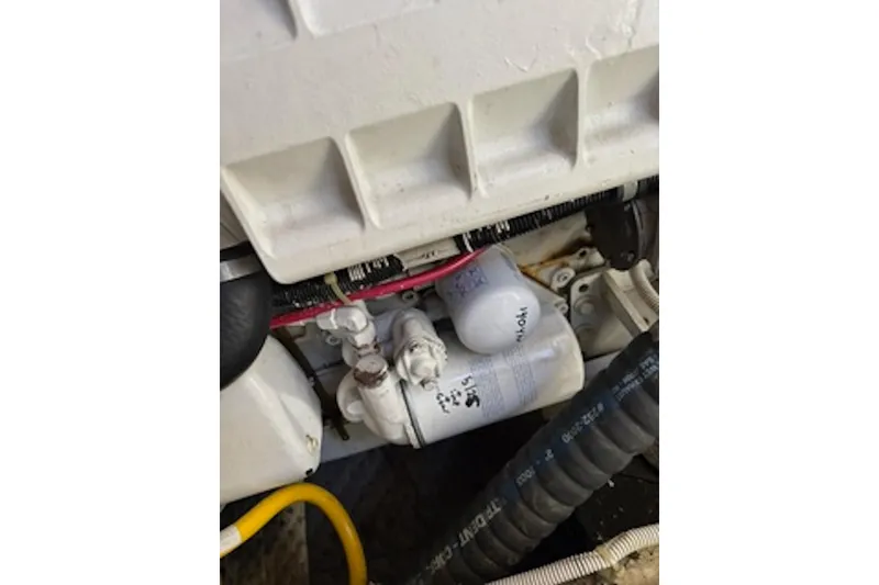Slide: The Image of Engine compartment of a 2004 Carver 396 Motor Yacht, showing filters and hoses. - 21