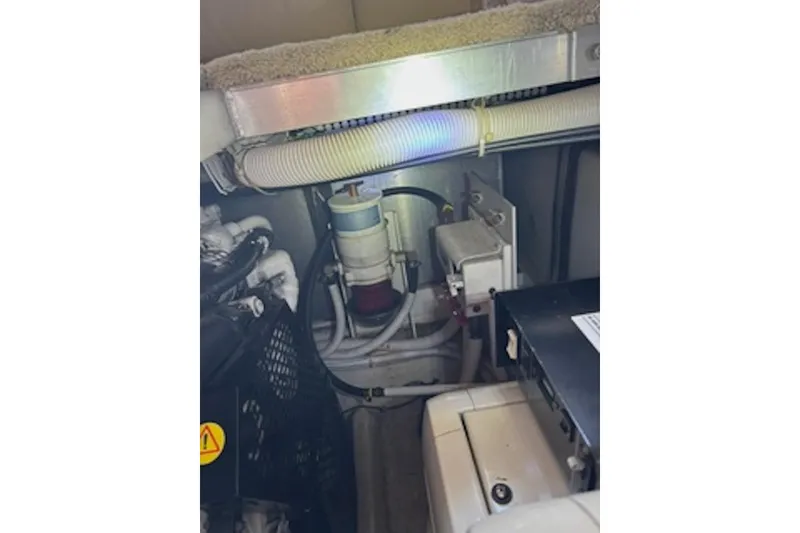 Slide: The Image of Engine compartment of a 2004 Carver 396 Motor Yacht, showing mechanical components. - 23