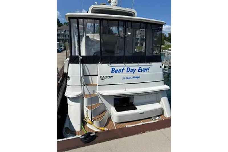 Slide: The Image of 2004 Carver 396 Motor Yacht docked, featuring "Best Day Ever!" text on the stern. - 3