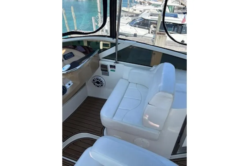 Slide: The Image of Interior of 2004 Carver 396 Motor Yacht with white seating and wood flooring. - 4