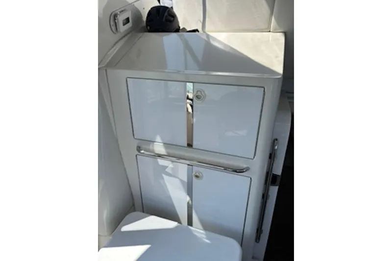 Slide: The Image of 2004 Carver 396 Motor Yacht interior with sleek white cabinetry and modern design. - 5