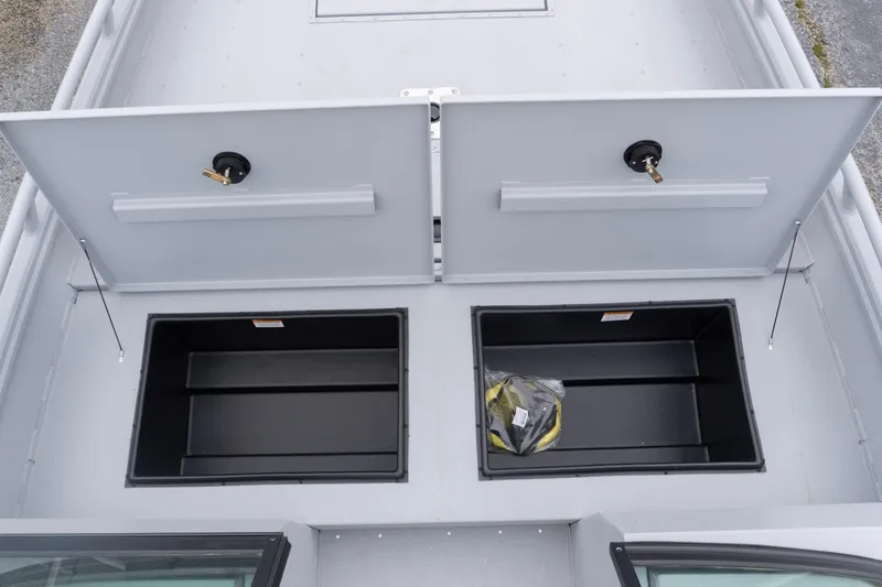 Slide: The Image of 2026 G3 Sportsman 2400 boat storage compartments with open lids, showcasing interior space. - 10