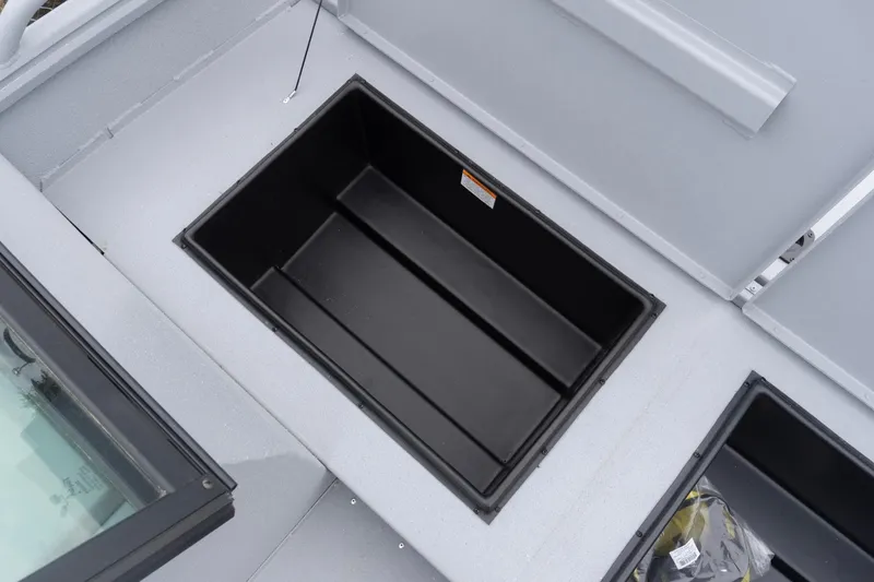 Slide: The Image of Open storage compartment on 2026 G3 Sportsman 2400 boat deck. - 11