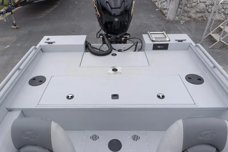 Slide: The Image of 2026 G3 Sportsman 2400 boat deck with motor, storage compartments, and seating. - 17
