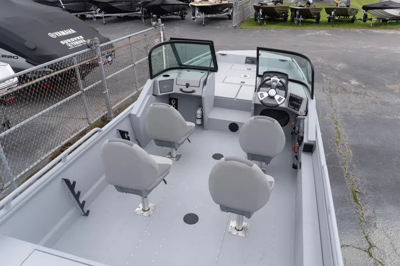 Slide: The Image of 2026 G3 Sportsman 2400 boat interior with four seats and steering console. - 5