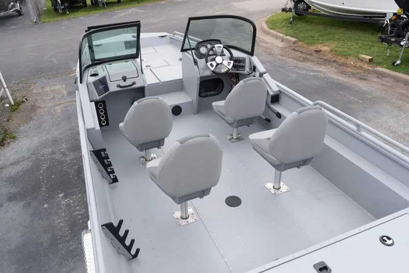 Slide: The Image of 2026 G3 Sportsman 2400 boat interior with four seats and steering console. - 6