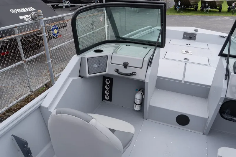 Slide: The Image of 2026 G3 Sportsman 2400 boat interior with seating, dashboard, and storage compartments. - 7