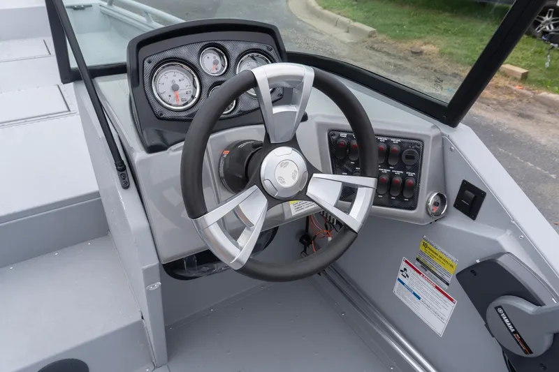 Slide: The Image of 2026 G3 Sportsman 2400 boat dashboard with steering wheel and control panel. - 8