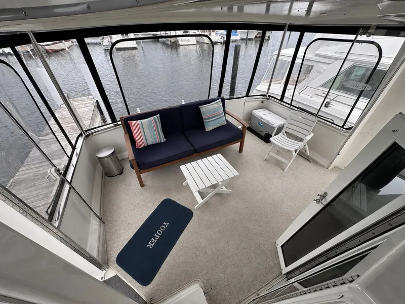 Slide: The Image of 1999 Carver 406 Yacht with cozy aft cabin deck. - 12