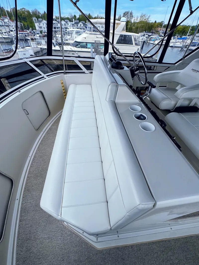 Slide: The Image of Interior of 1999 Carver 406 Aft Cabin Yacht with white seating area. - 15