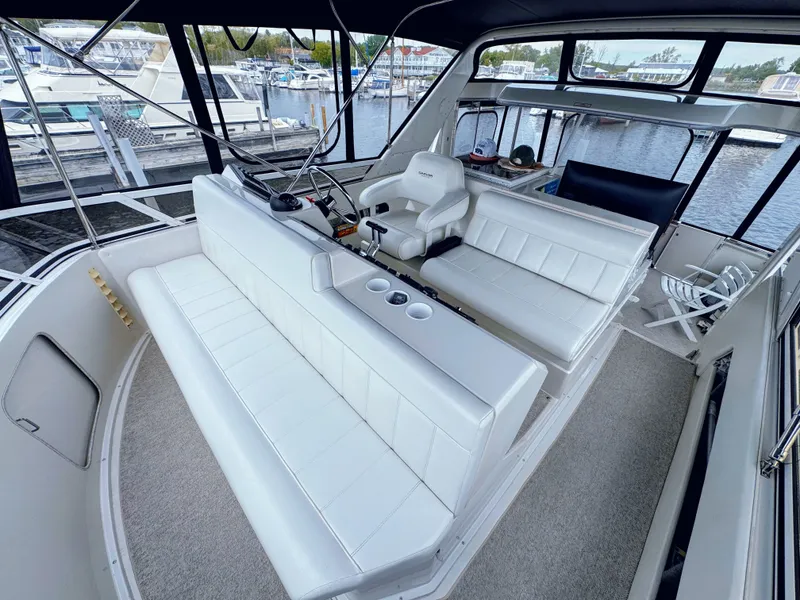 Slide: The Image of Interior of a 1999 Carver 406 Aft Cabin Yacht with white leather seating. - 16