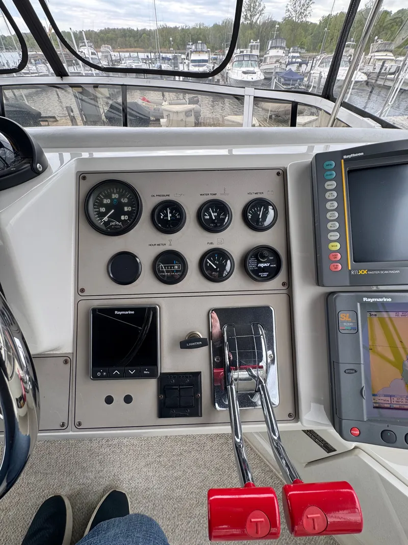 Slide: The Image of 1999 Carver 406 Aft Cabin Motor Yacht helm console at marina. - 22