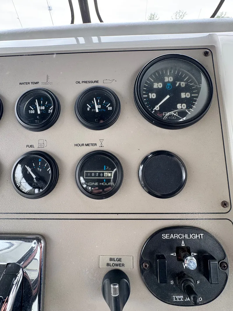 Slide: The Image of Carver 406 yacht dashboard with gauges and searchlight control. - 24