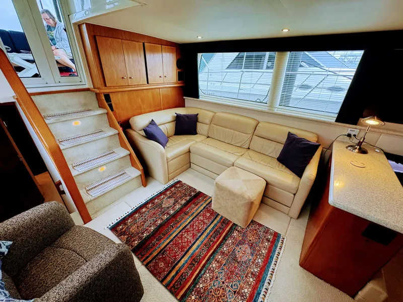 Slide: The Image of Interior of Carver 406 Aft Cabin Yacht, cozy living area with sofa. - 31