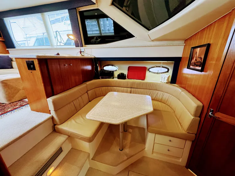 Slide: The Image of Interior of 1999 Carver 406 Aft Cabin Yacht with cozy seating area. - 35