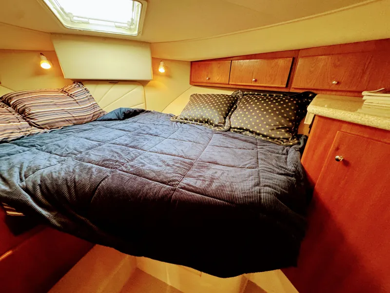 Slide: The Image of Interior of Carver 406 Aft Cabin Yacht, cozy bedroom with bed. - 37