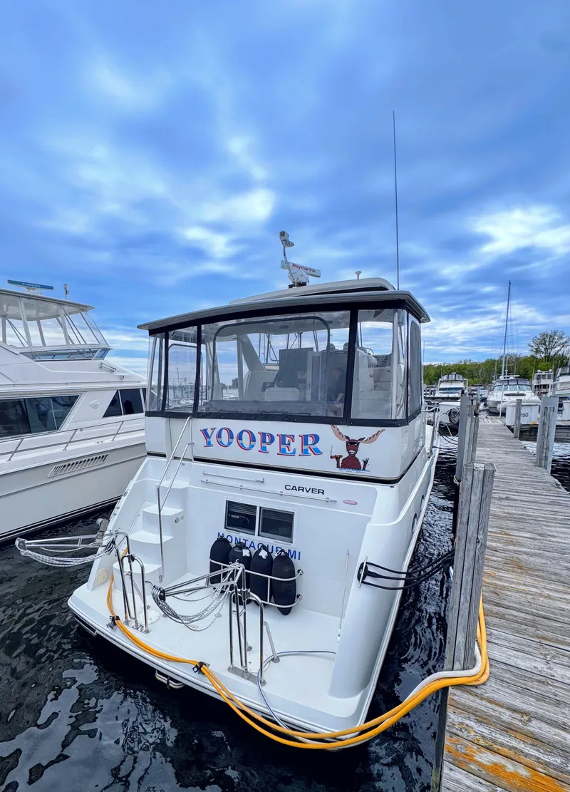 Slide: The Image of 1999 Carver 406 Aft Cabin Motor Yacht docked at marina. - 4