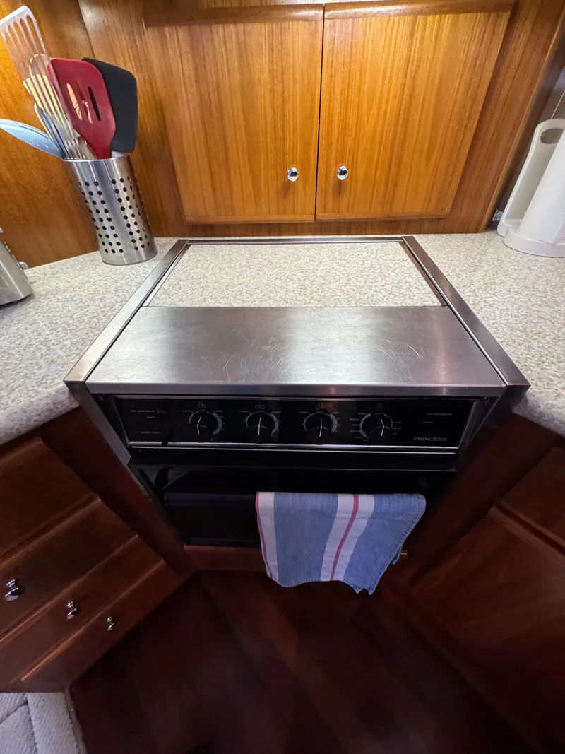 Slide: The Image of Carver 406 yacht kitchen area with stove and cabinets. - 41
