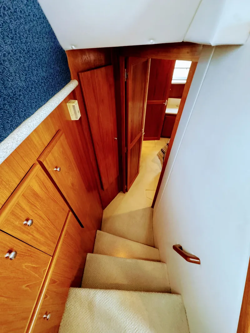 Slide: The Image of Interior of 1999 Carver 406 Aft Cabin Yacht with wooden furnishings. - 44