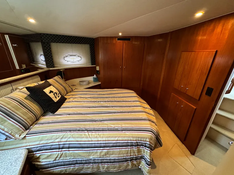 Slide: The Image of Interior of Carver 406 Aft Cabin Yacht, cozy bedroom with wooden furnishings. - 46