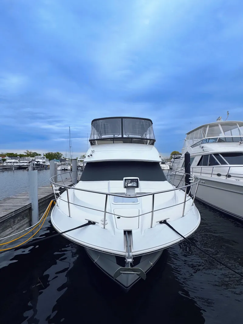 Slide: The Image of 1999 Carver 406 Aft Cabin Motor Yacht docked at marina. - 5