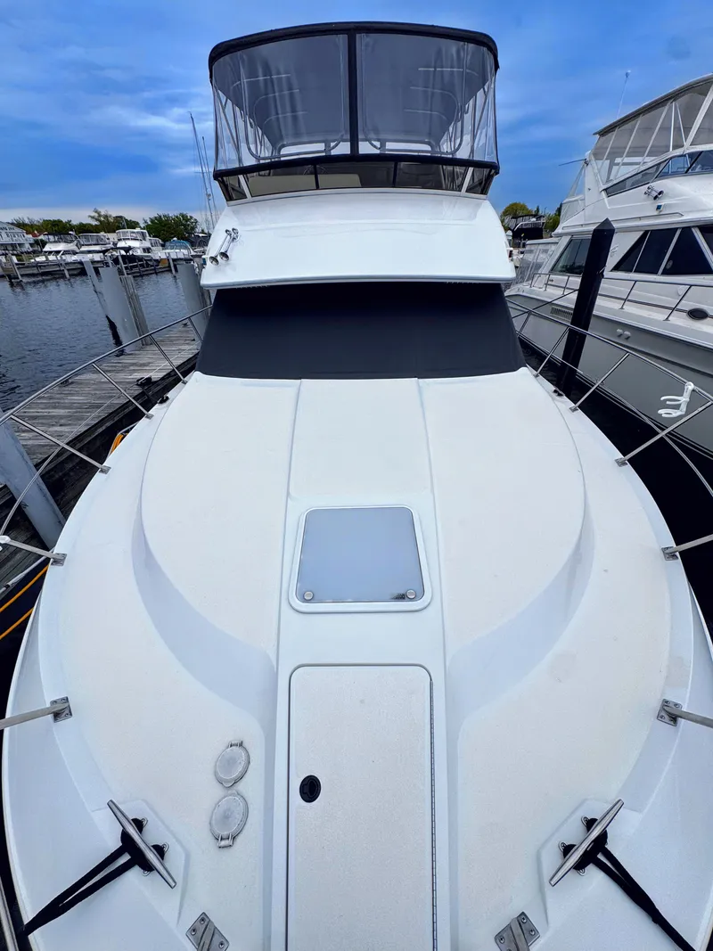 Slide: The Image of 1999 Carver 406 Aft Cabin Motor Yacht docked at marina. - 6