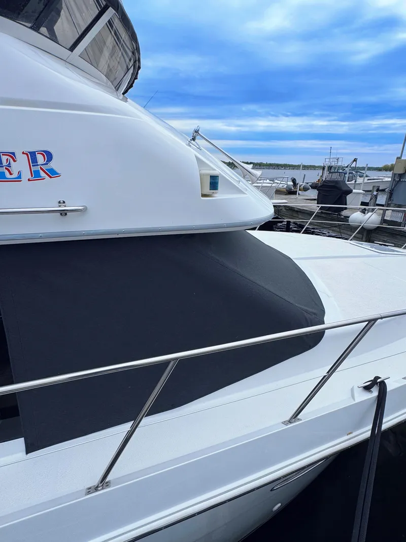 Slide: The Image of 1999 Carver 406 Aft Cabin Motor Yacht docked at marina. - 8
