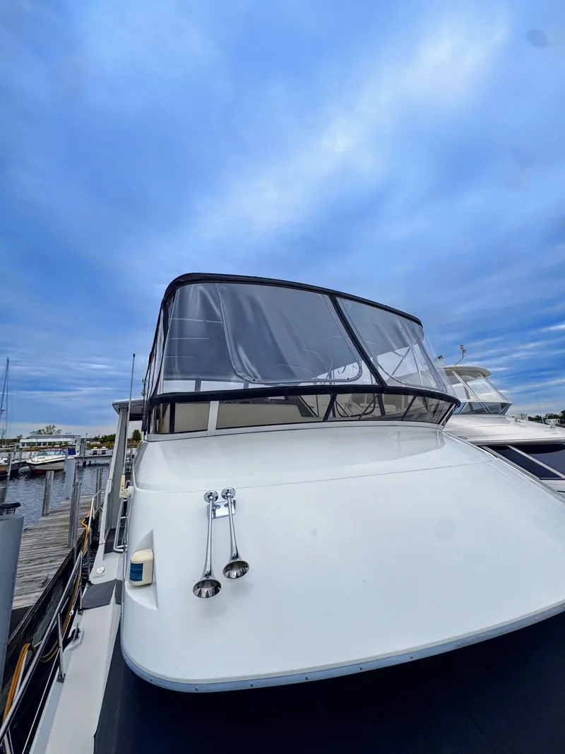Slide: The Image of 1999 Carver 406 Aft Cabin Motor Yacht docked at marina. - 9
