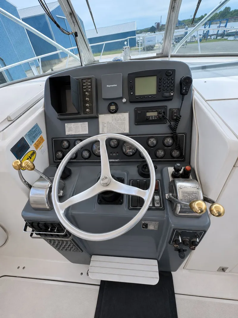 Slide: The Image of Helm of a 1999 Pursuit 3400 Express boat. - 12