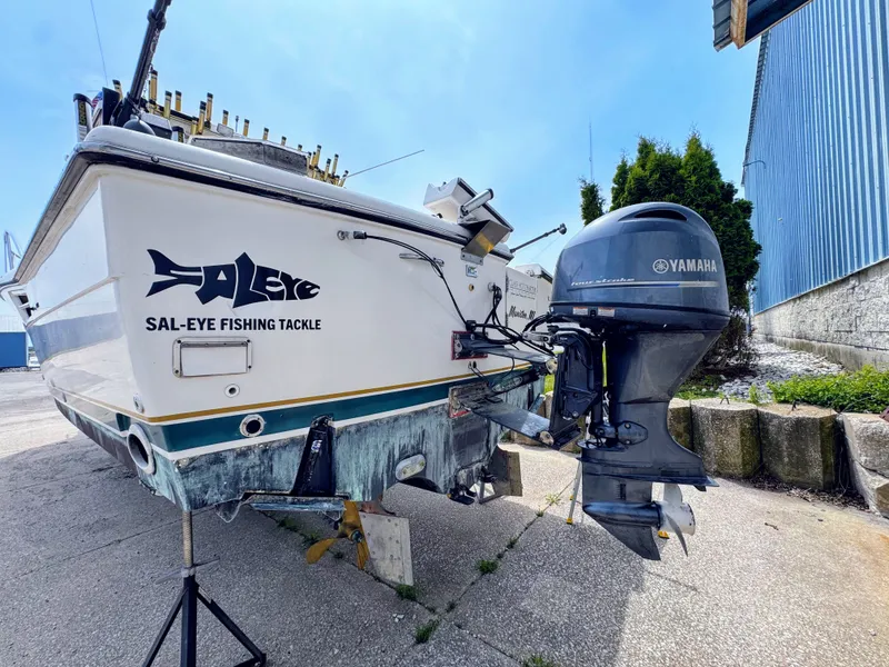 Slide: The Image of 1999 Pursuit 3400 Express boat with Yamaha outboard motor. - 5