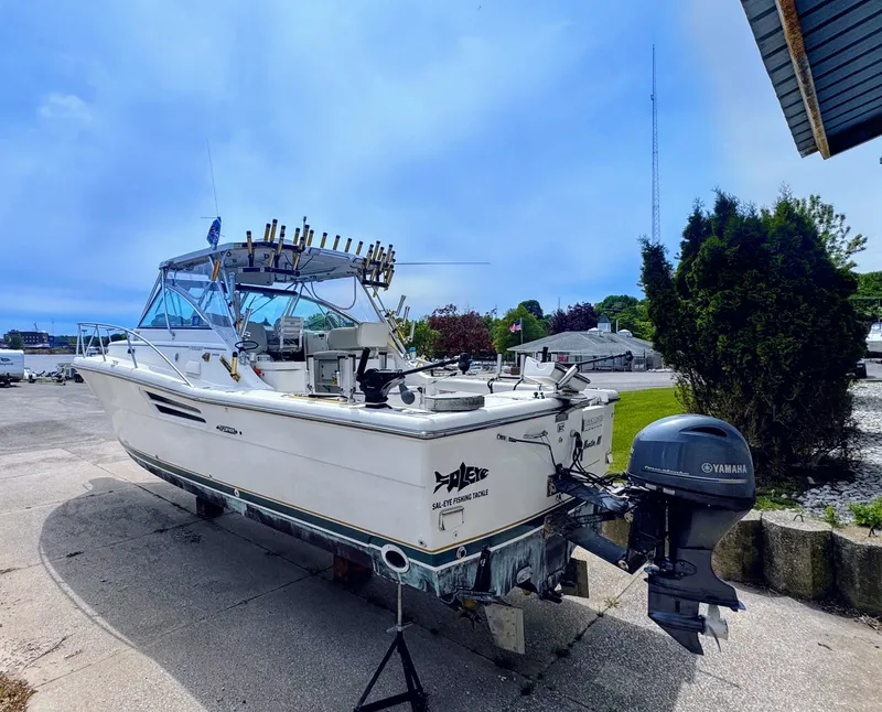 Slide: The Image of 1999 Pursuit 3400 Express boat with Yamaha outboard motor. - 6