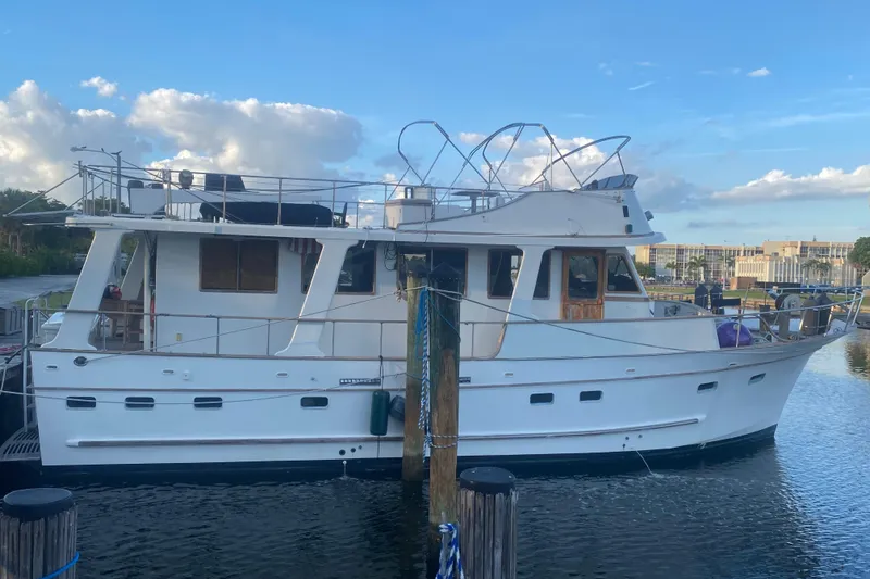 The Image of 1985 Marine Trader 50 Motor Yacht docked at marina under blue sky. - 1