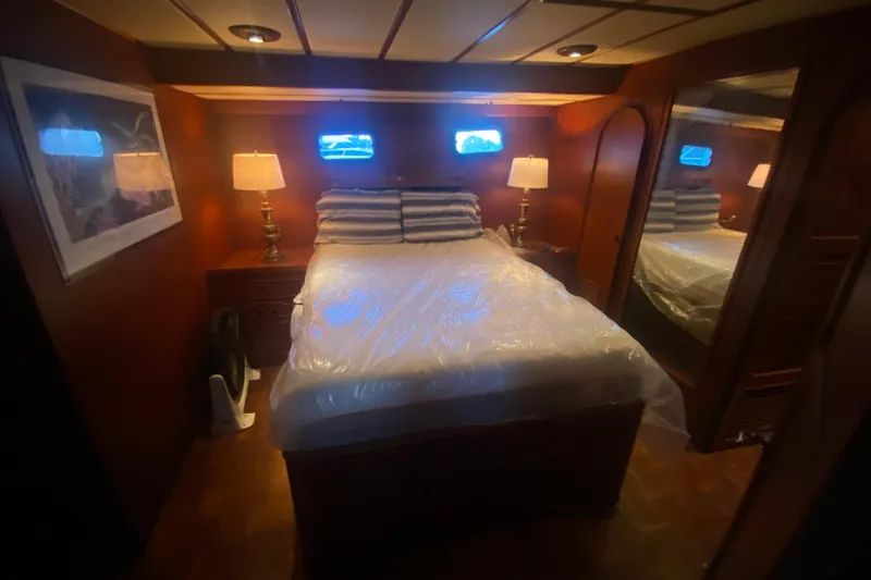 Slide: The Image of Cozy bedroom in 1985 Marine Trader 50 Motor Yacht with warm lighting and nautical decor. - 10