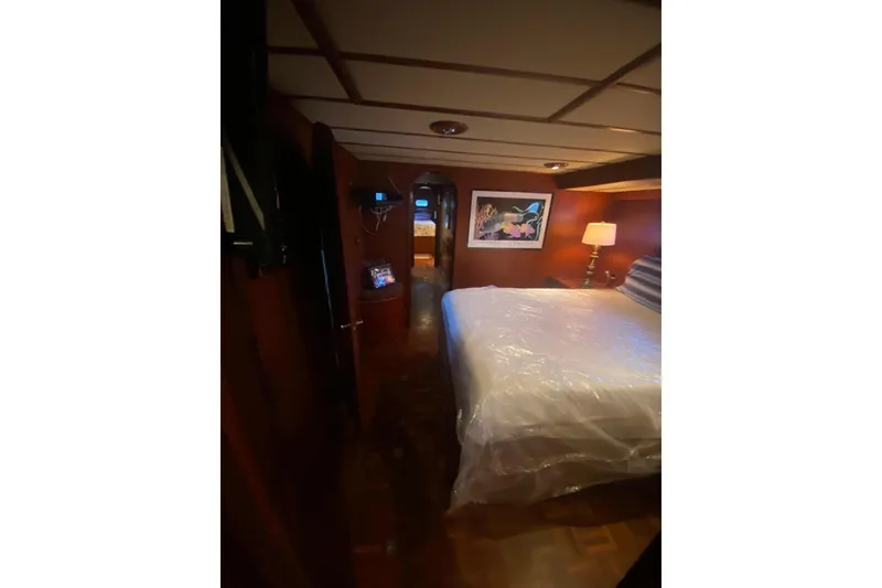 Slide: The Image of Interior of 1985 Marine Trader 50 Motor Yacht with cozy bedroom and elegant decor. - 11