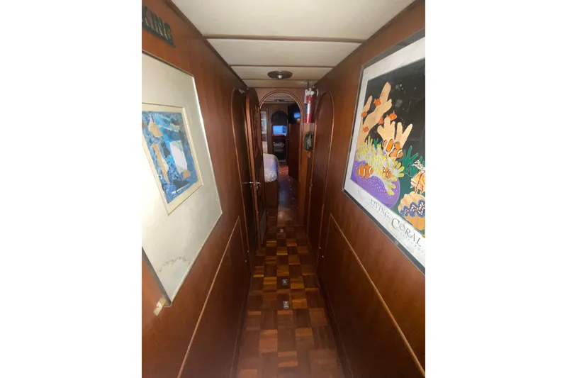 Slide: The Image of Narrow hallway inside 1985 Marine Trader 50 Motor Yacht with artwork on walls. - 9