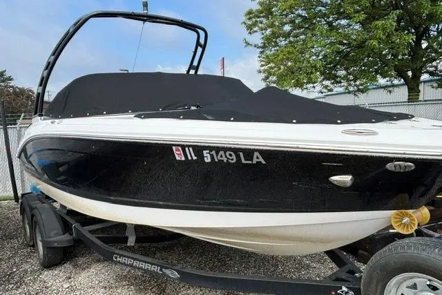 Slide: The Image of 2021 Chaparral 21 SSi boat on trailer, black cover, parked outdoors. - 24
