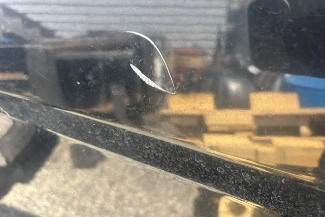 Slide: The Image of Close-up of a scratch on a 2021 Chaparral 21 SSi boat hull. - 29