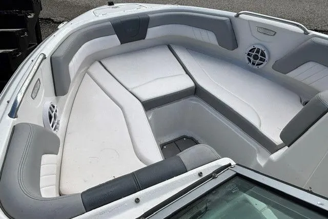 Slide: The Image of 2021 Chaparral 21 SSi boat interior with gray and white seating, featuring speakers. - 4
