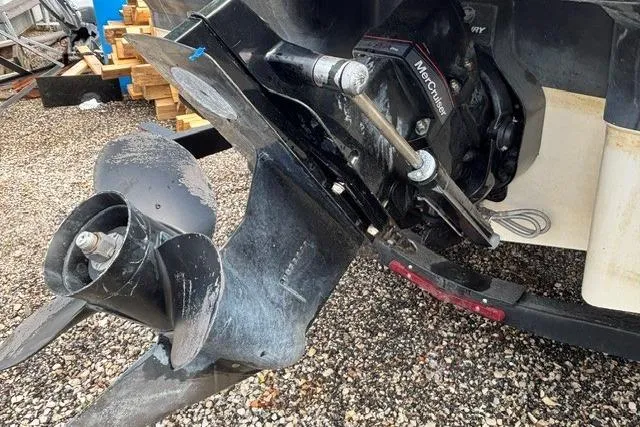 Slide: The Image of 2021 Chaparral 21 SSi boat's outboard motor and propeller on gravel surface. - 41