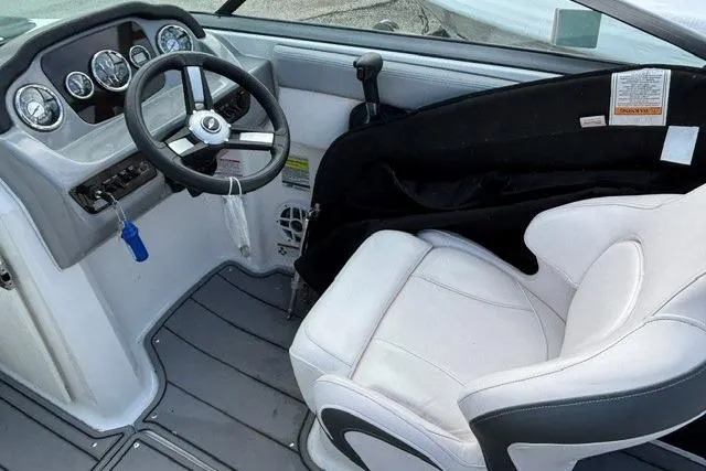 Slide: The Image of Interior of 2021 Chaparral 21 SSi boat, featuring steering wheel and white captain's seat. - 5