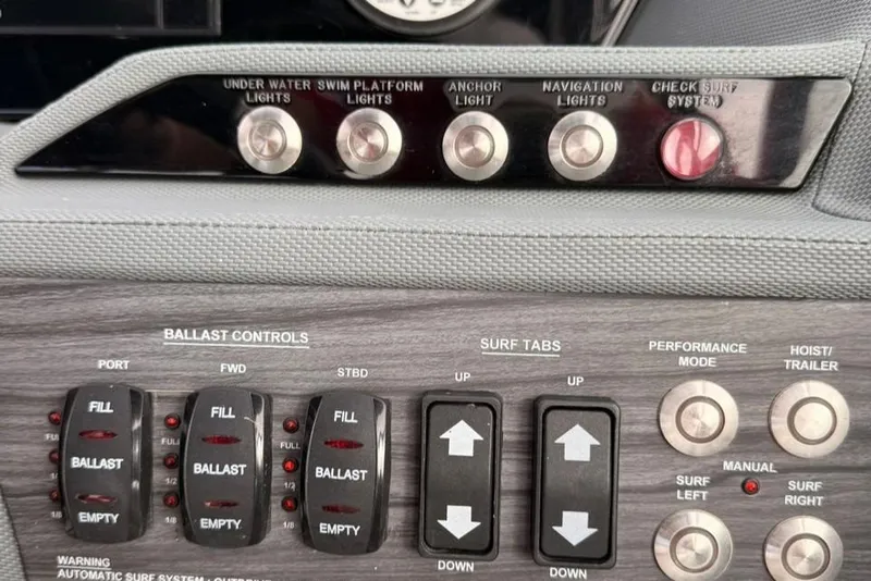Slide: The Image of Control panel of a 2018 Cobalt R5 WSS Surf boat with ballast and surf system controls. - 27