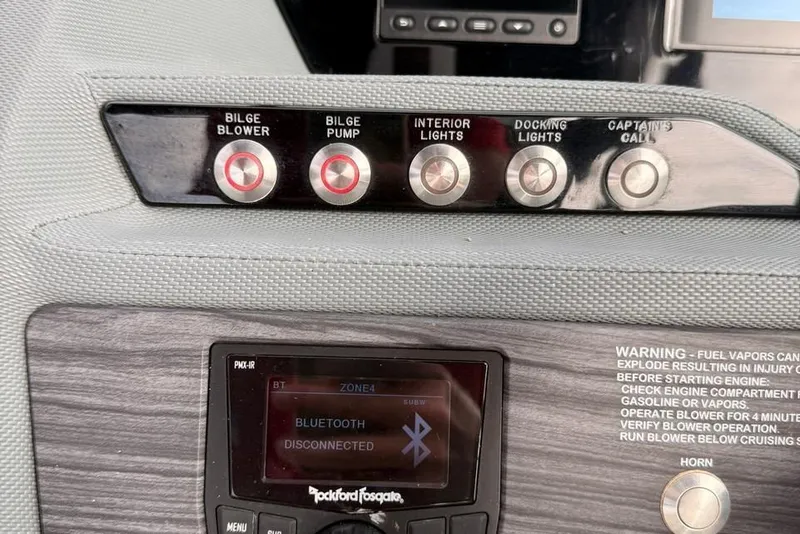 Slide: The Image of Control panel of a 2018 Cobalt R5 WSS Surf boat with various switches and Bluetooth display. - 30