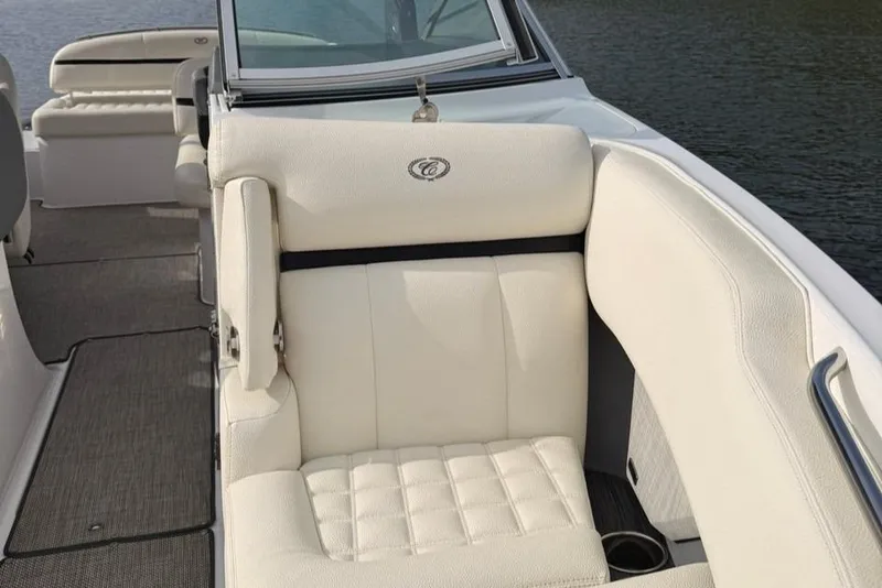 Slide: The Image of 2018 Cobalt R5 WSS Surf boat with luxurious white seating on a calm water backdrop. - 33