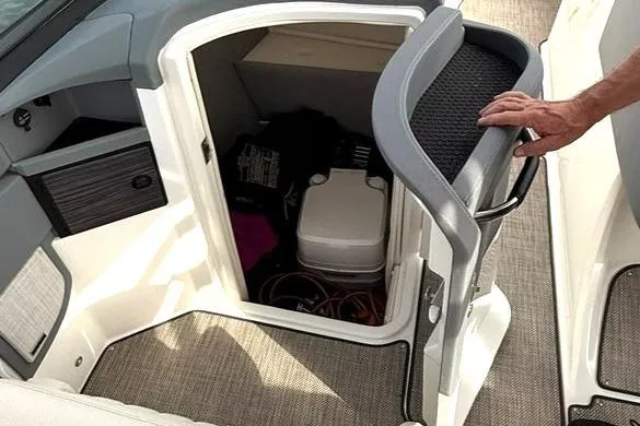 Slide: The Image of 2018 Cobalt R5 WSS Surf boat interior with storage compartment and portable toilet. - 35