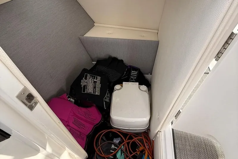 Slide: The Image of Storage compartment in a 2018 Cobalt R5 WSS Surf boat with life jackets and equipment. - 36