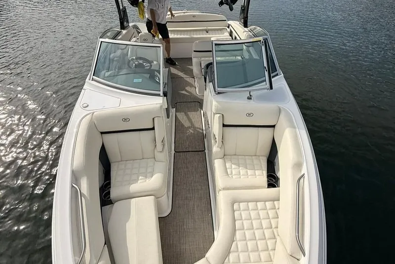 Slide: The Image of 2018 Cobalt R5 WSS Surf boat with luxurious white seating on calm water. - 4